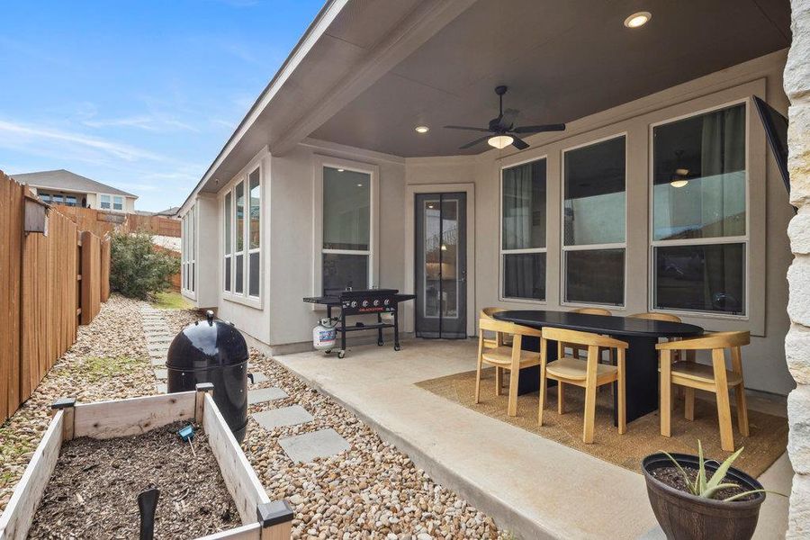 View of patio / terrace featuring a ceiling fan and fence