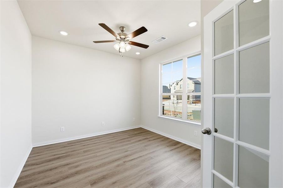 Empty room with light wood-type flooring, ceiling fan, and recessed lighting