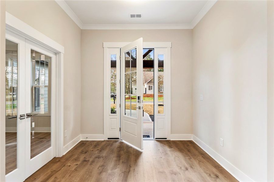 This versatile room features elegant wainscoting a