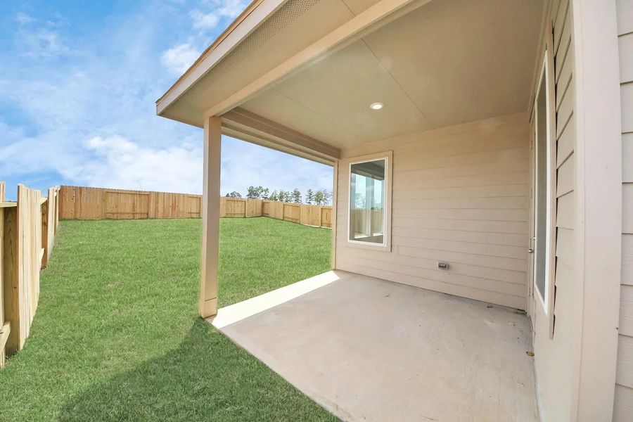 Exterior details and patio area of a home in The Canopies, Splendora (Image 2).