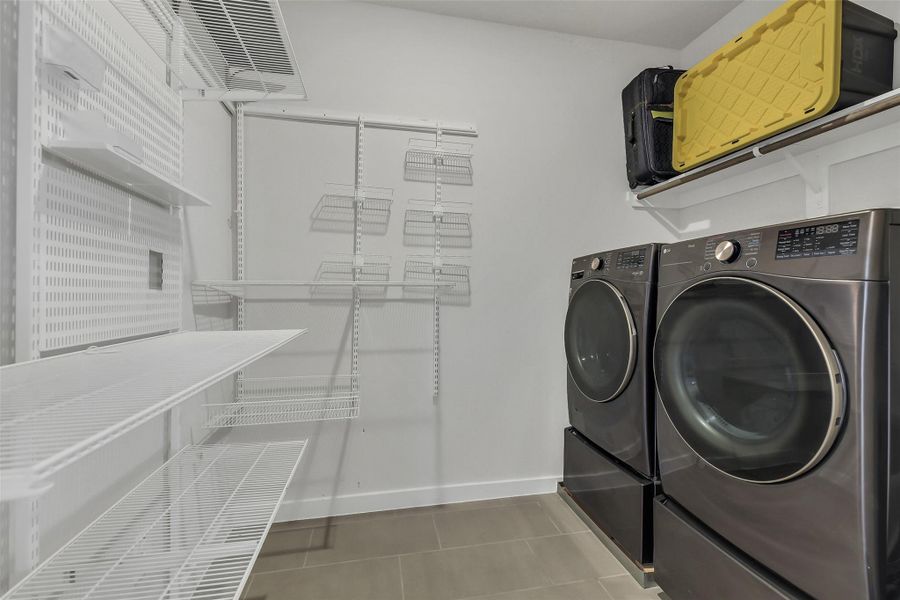 Dedicated laundry room with additional storage potential and functional space designed for convenience and organization.