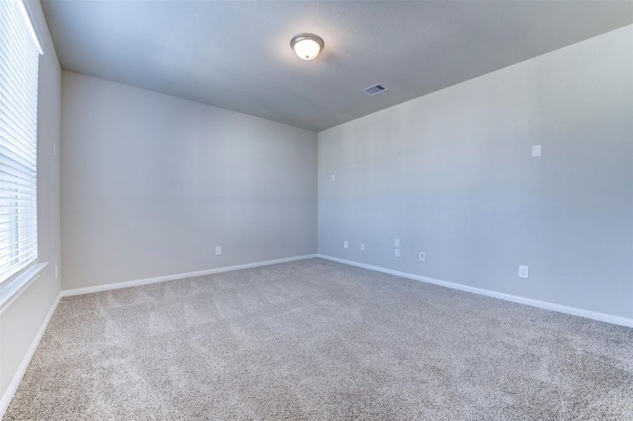 Media room with plush carpet, recessed lighting, and flexible space for entertainment.