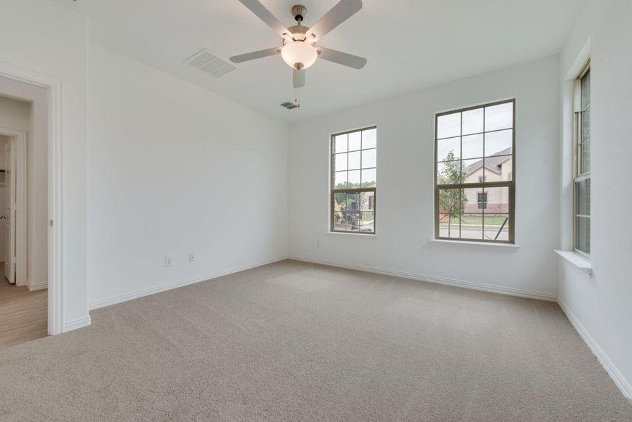 Spare room with light colored carpet and ceiling fan Spare room with light colored carpet and ceiling fan