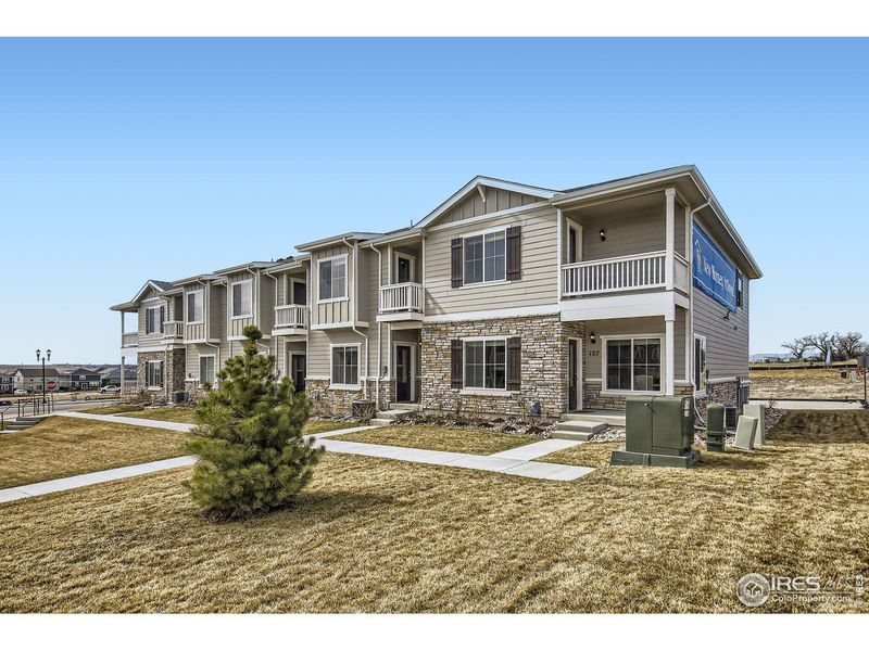 Front exterior of a new home in Johnstown Village, Johnstown, CO, highlighting curb appeal (Image 25).