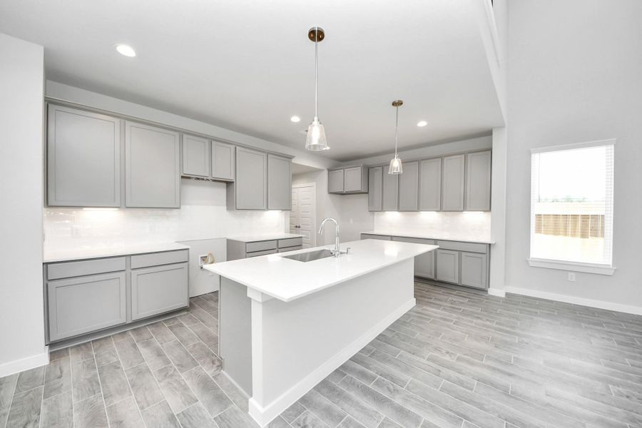 This kitchen is by far any chef’s dream! This spacious kitchen features high ceilings, light stained wood cabinets, granite countertop, SS appliances, modern tile backsplash, recessed lighting, extended counter space, granite kitchen island with double sink, and space for breakfast bar, and a walk-in pantry all overlooking your huge family room. Sample photo of completed home with similar floor plan. Actual colors and selections may vary. This kitchen is by far any chef’s dream! This spacious kitchen features high ceilings, light stained wood cabinets, granite countertop, SS appliances, modern tile backsplash, recessed lighting, extended counter space, granite kitchen island with double sink, and space for breakfast bar, and a walk-in pantry all overlooking your huge family room. Sample photo of completed home with similar floor plan. Actual colors and selections may vary.