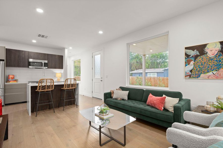 Open-concept living area with wood-finish flooring