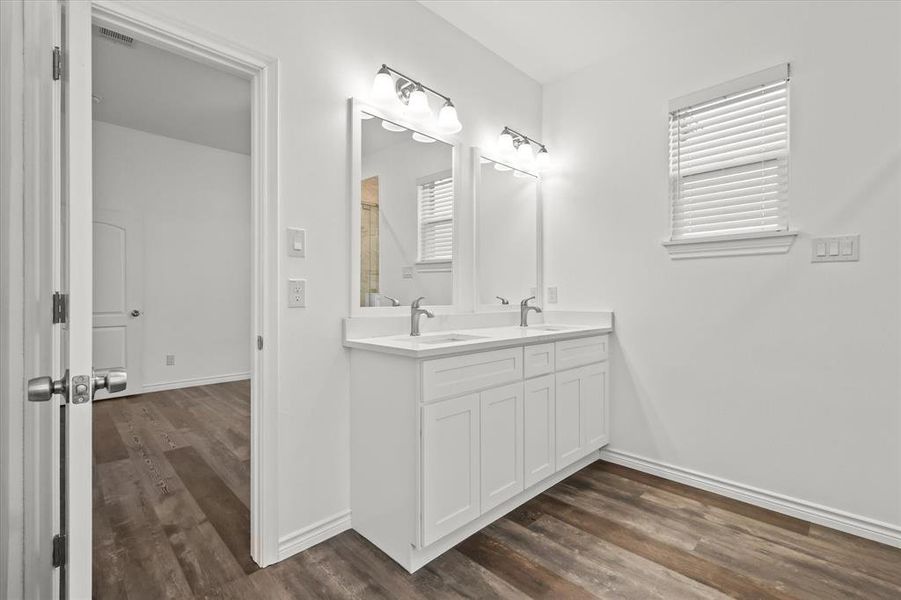 Bathroom with vanity and hardwood / wood-style floors