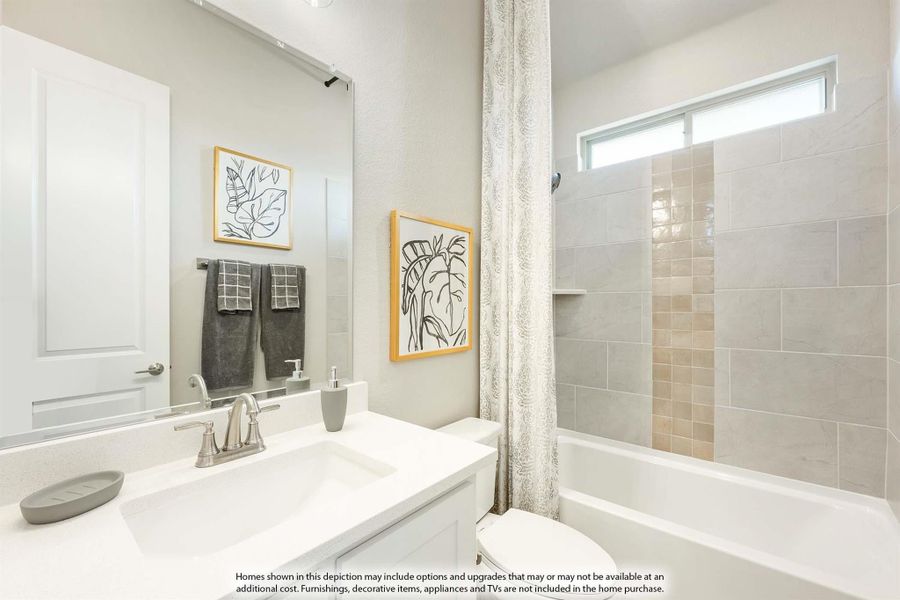 Bathroom with white vanity, large mirror, and tub-shower combo with beige tile surround