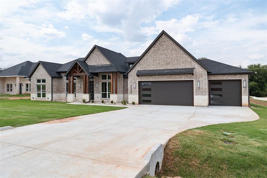 Front exterior of a new home in Pecan Plantation, Granbury, TX, highlighting curb appeal (Image 2). Front exterior of a new home in Pecan Plantation, Granbury, TX, highlighting curb appeal (Image 2).