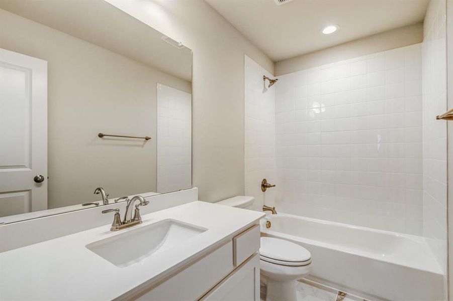 Bathroom with vanity, shower / tub combination, and recessed lighting