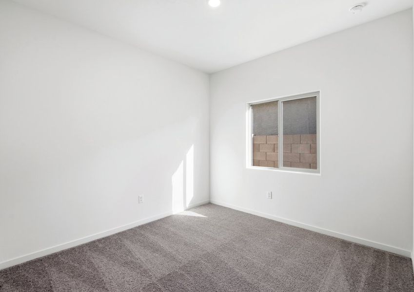 Windows let in plenty of light to this secondary bedroom.