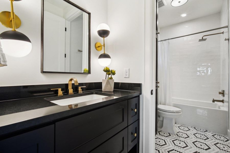 Full bathroom with tile patterned flooring, visible vents, toilet, shower / tub combo with curtain, and vanity