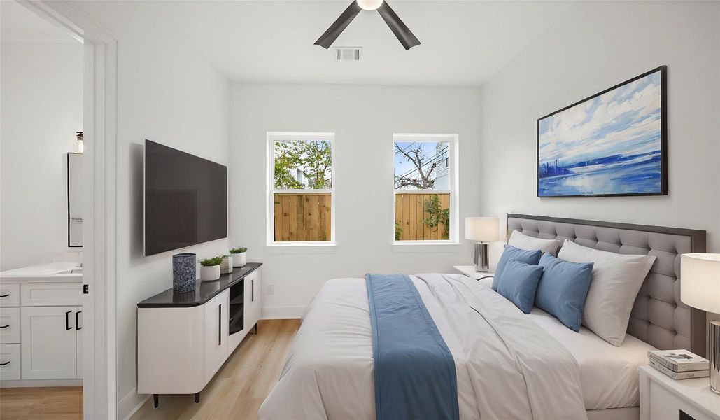 Virtually Staged: Beautiful secondary bedroom with luxury vinyl plank floors, a ceiling fan, and a complete en-suite bathroom.