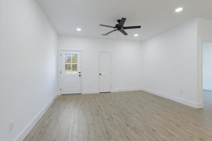 Unfurnished room with ceiling fan and light hardwood / wood-style floors