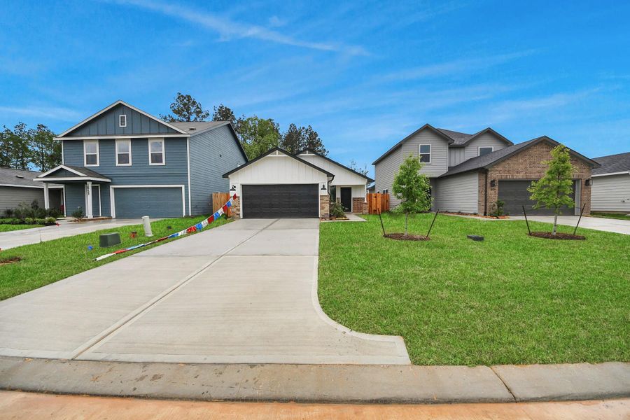 Front exterior of a new home in The Enclave at Spring Branch, Montgomery, TX, highlighting curb appeal (Image 21). Front exterior of a new home in The Enclave at Spring Branch, Montgomery, TX, highlighting curb appeal (Image 21).