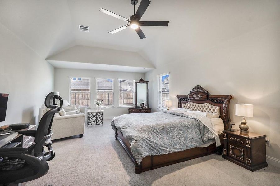 Bedroom featuring carpet flooring, a ceiling fan, and lofted ceiling Bedroom featuring carpet flooring, a ceiling fan, and lofted ceiling