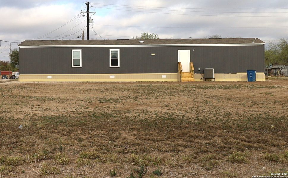 Front exterior of a new home in , Poteet, TX, highlighting curb appeal (Image 2).