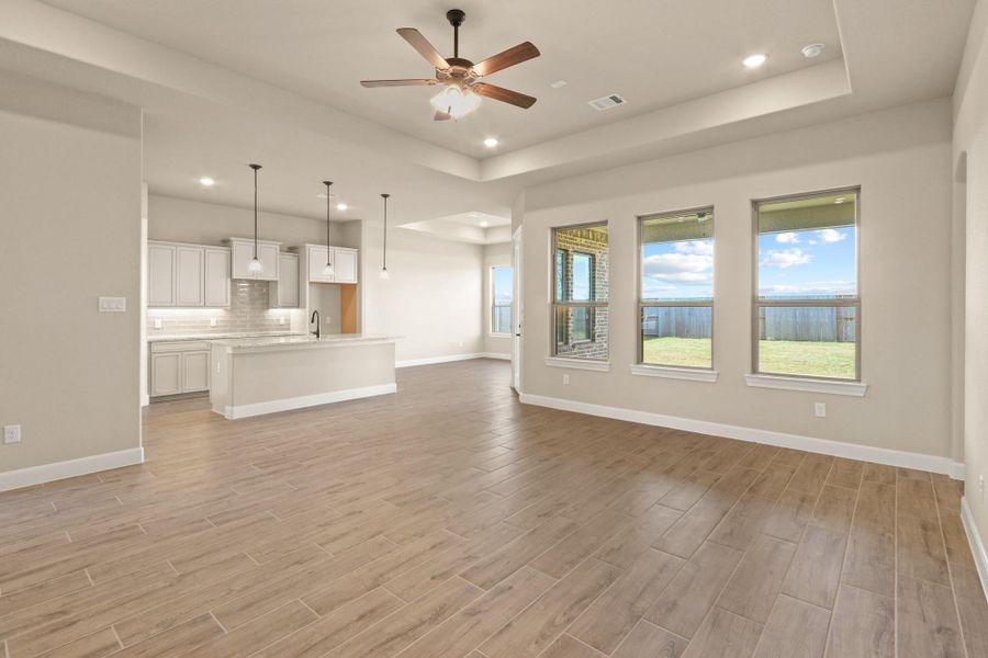 The expansive open-concept living area features a striking wall of windows that flood the space with natural light while offering serene views of the picturesque backyard—creating a perfect blend of indoor comfort and outdoor beauty. The expansive open-concept living area features a striking wall of windows that flood the space with natural light while offering serene views of the picturesque backyard—creating a perfect blend of indoor comfort and outdoor beauty.