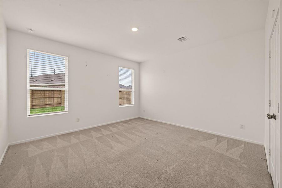 Spacious primary suite tucked privately at the rear of the home, offering plenty of room to unwind and recharge at the end of the day.