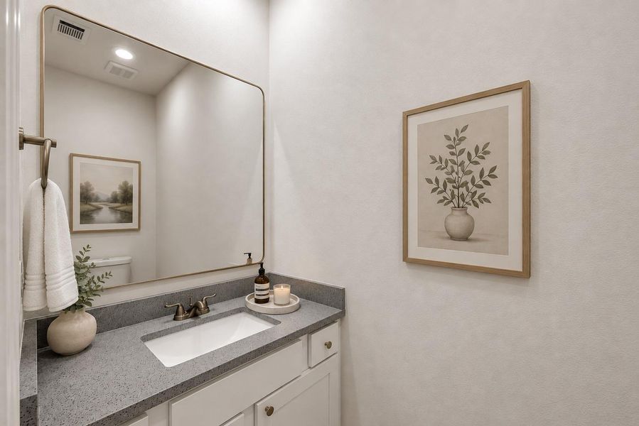 This elegant first-floor half bath features a sleek vanity, stylish decor, and a soothing ambiance, perfect for guest convenience and modern living.