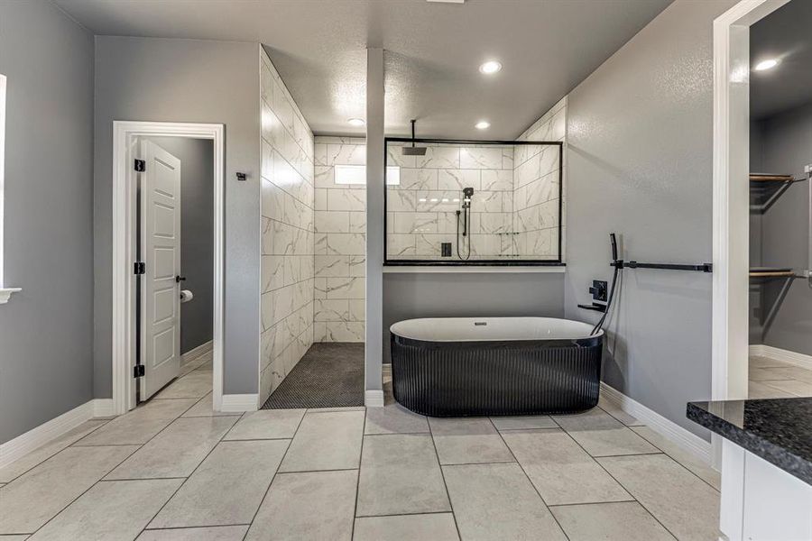 Bathroom with plus walk in shower and tile patterned floors