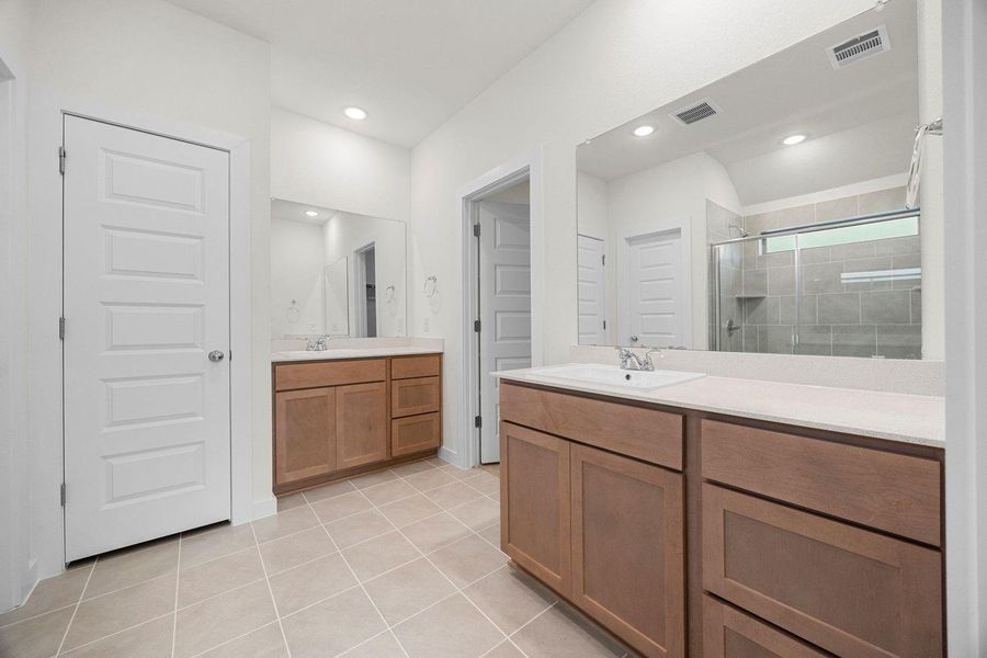 Primary Bathroom in the Sabine home plan by Trophy Signature Homes – REPRESENTATIVE PHOTO