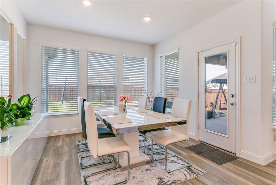 Dining room with plenty of natural light, light wood-style flooring, and recessed lighting