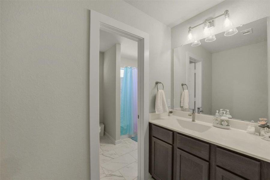 Additional bathroom offers convenience for family and guests.