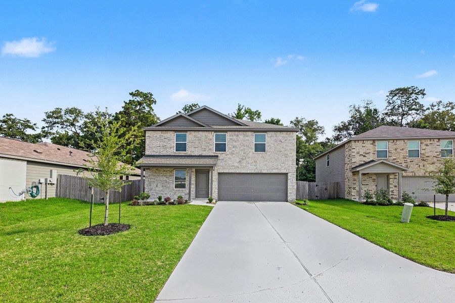 Front exterior of a new home in Hill and Dale Ranch, Splendora, TX, highlighting curb appeal (Image 13).