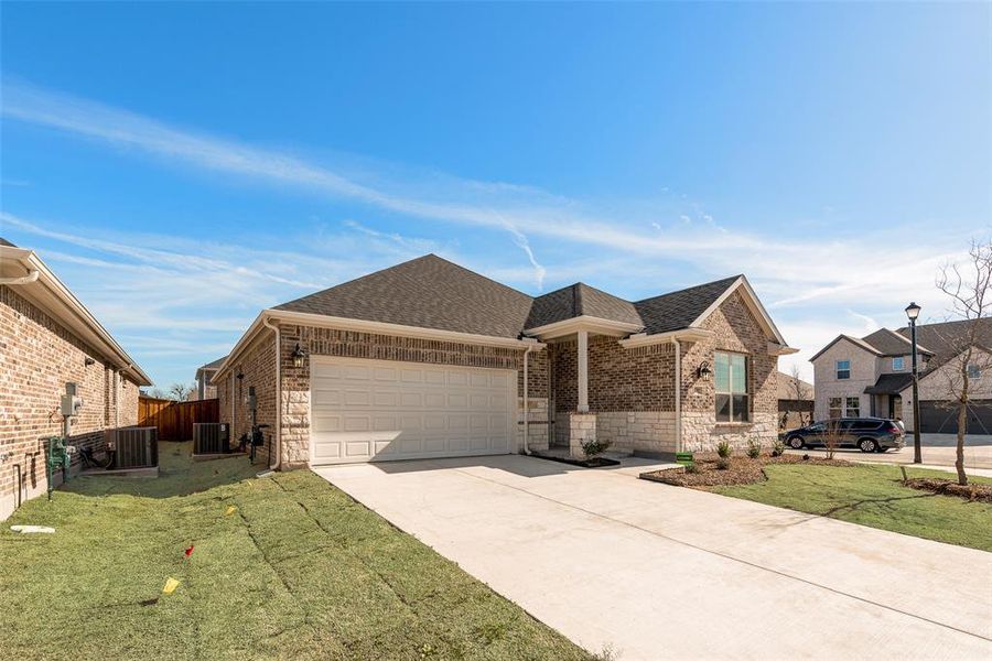Front exterior of a new home in Walden Pond, Forney, TX, highlighting curb appeal (Image 2). Front exterior of a new home in Walden Pond, Forney, TX, highlighting curb appeal (Image 2).