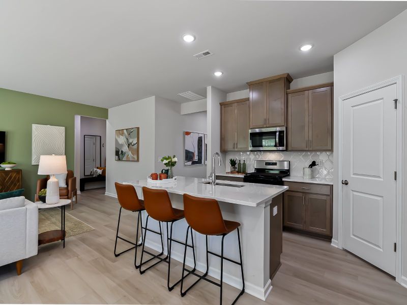 The kitchen provides ample prep and storage space with a sizeable island overlooking the great room.