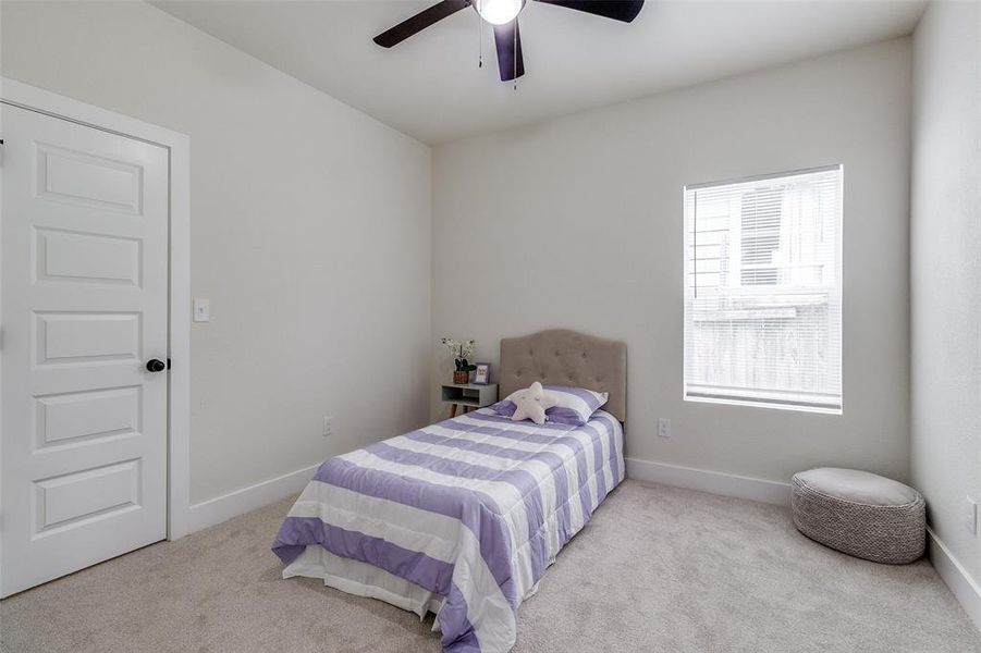 Carpeted bedroom with ceiling fan