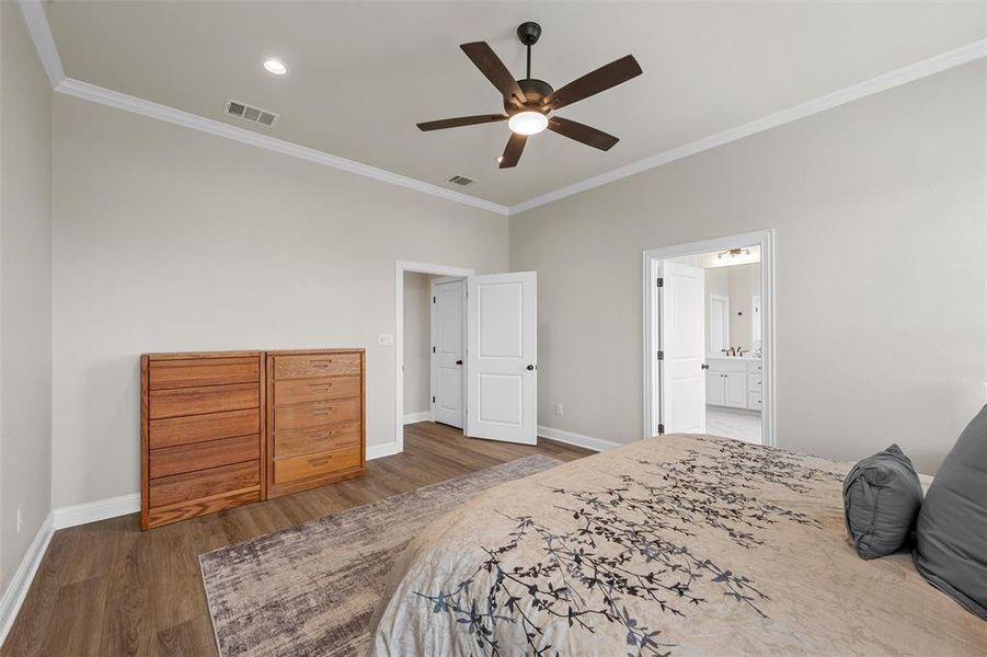 Primary bedroom with luxury vinyl plank flooring, ceiling fan, and natural light. Primary bedroom with luxury vinyl plank flooring, ceiling fan, and natural light.