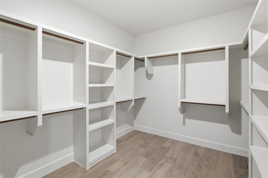 Integrated shelving and hanging rods define this well-appointed closet, providing ample storage for organized living. Integrated shelving and hanging rods define this well-appointed closet, providing ample storage for organized living.