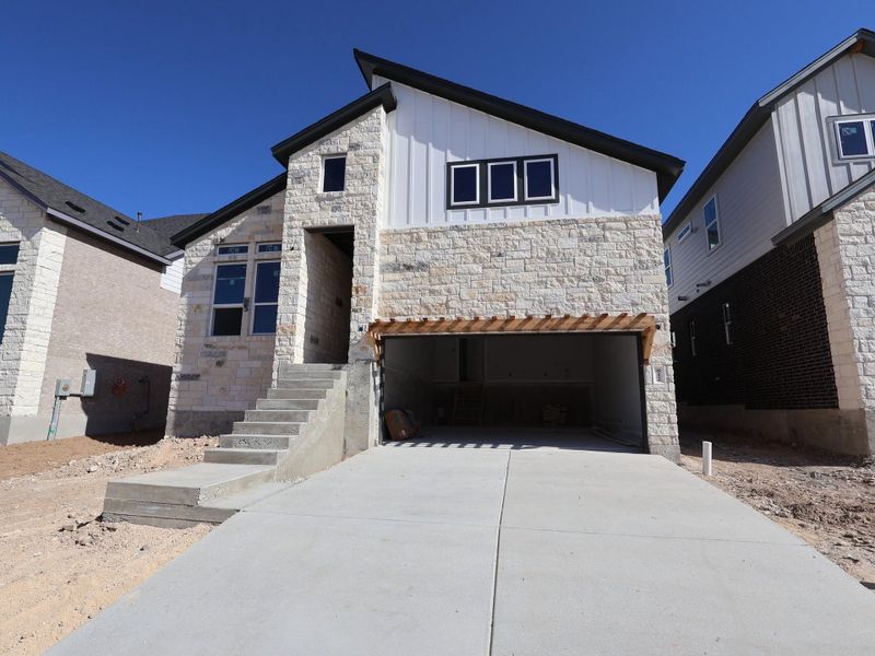 Front exterior of a new home in Cedar Brook, Leander, TX, highlighting curb appeal (Image 2).
