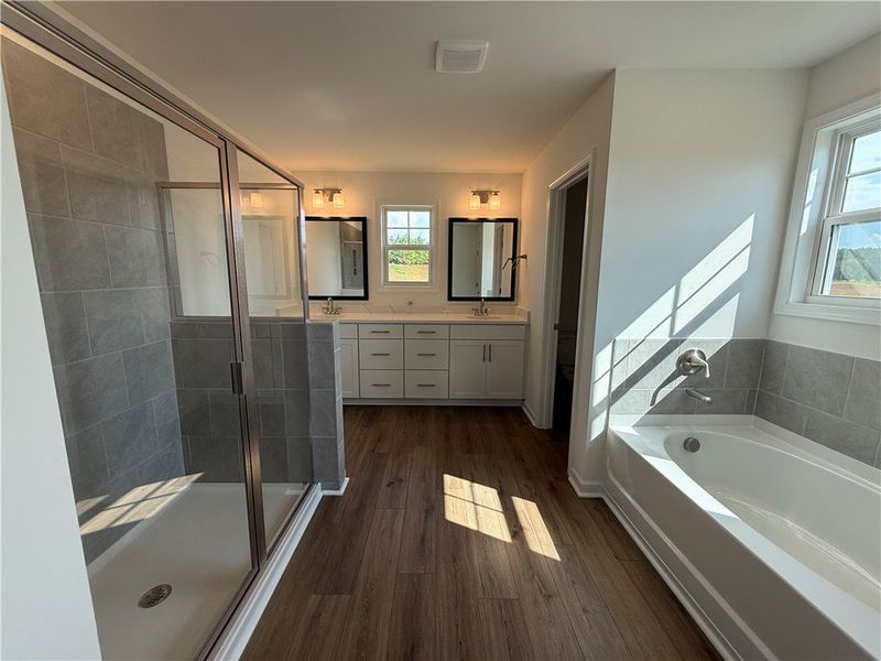 A generously sized primary bathroom offers a walk- A generously sized primary bathroom offers a walk-