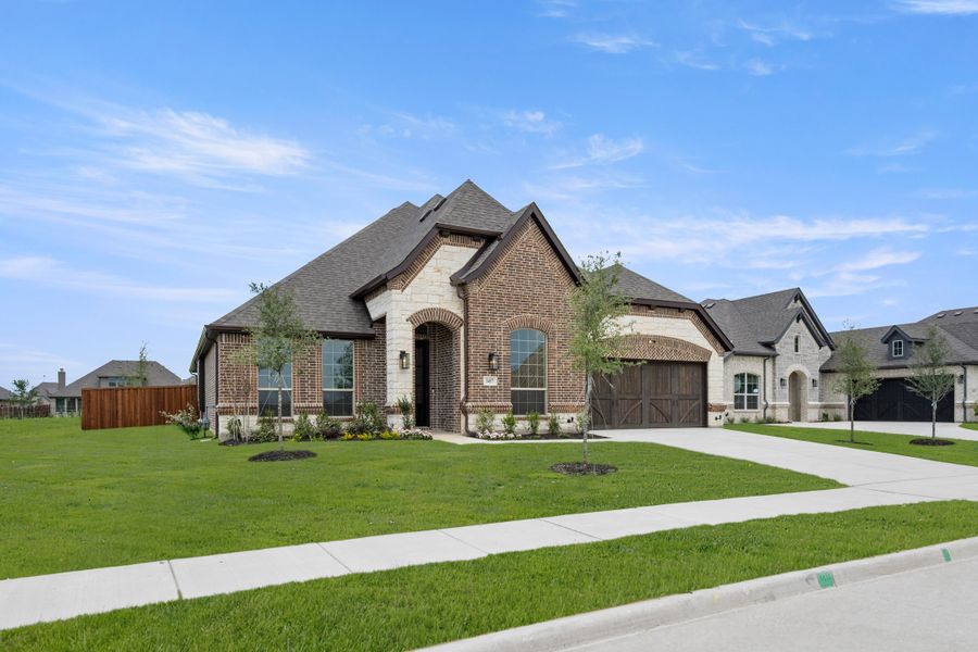 Front exterior of a new home in Redden Farms, Midlothian, TX, highlighting curb appeal (Image 2). Front exterior of a new home in Redden Farms, Midlothian, TX, highlighting curb appeal (Image 2).