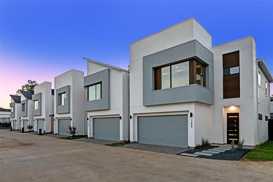 Villas de Marbella community featuring two-story designs, attached garages, and a mix of stucco and wood siding.