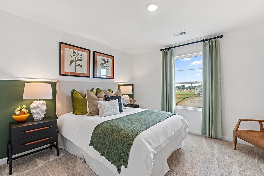 A bedroom with a large window. A bedroom with a large window.