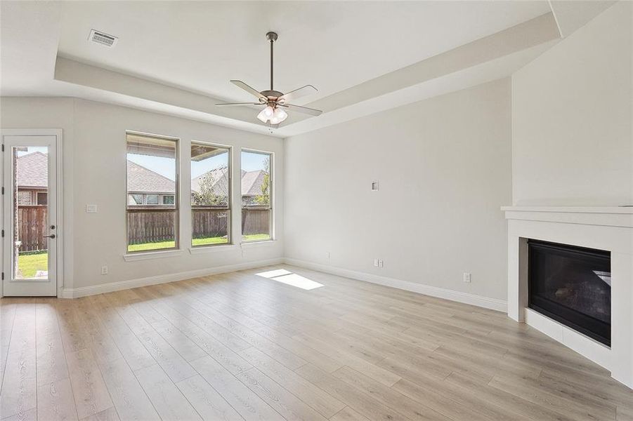 Unfurnished living room with light hardwood / wood-style flooring and ceiling fan