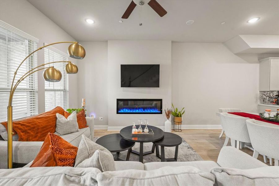 Living room with ceiling fan and light wood-type flooring