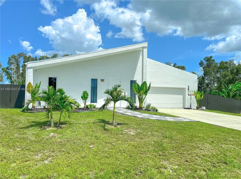 Front exterior of a new home in , Lehigh Acres, FL, highlighting curb appeal (Image 28). Front exterior of a new home in , Lehigh Acres, FL, highlighting curb appeal (Image 28).