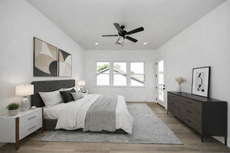 Spacious primary bedroom with great natural light and private balcony access—perfect for a quiet retreat.