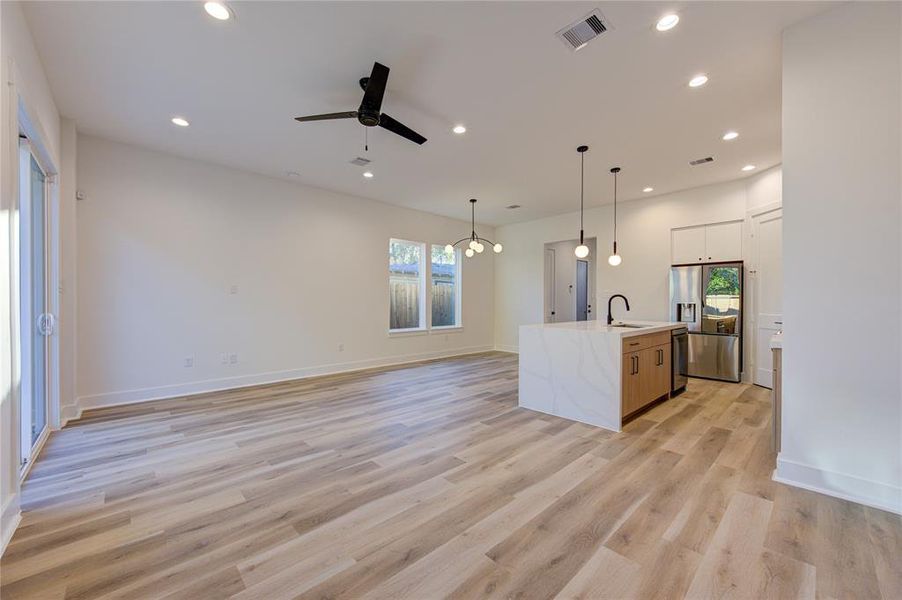 Open floor plan with large living room area that opens to the dining and kitchen area. Home comes with LED recessed lighting and ceiling fans pre-installed in all rooms.