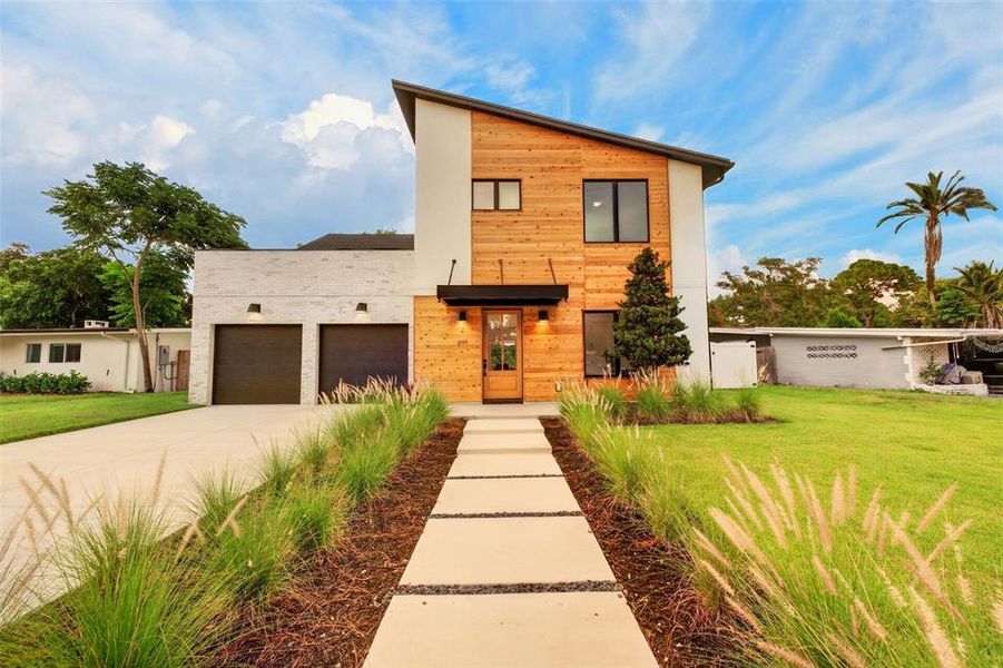Front exterior of a new home in , Orlando, FL, highlighting curb appeal (Image 1). Front exterior of a new home in , Orlando, FL, highlighting curb appeal (Image 1).