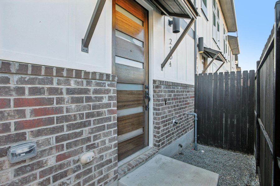 Exterior details and patio area of a home in Koenig Townhomes, Austin (Image 4).