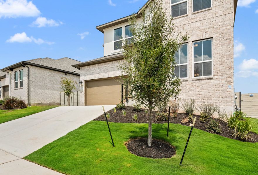 Front exterior of a new home in Wolf Ranch, Georgetown, TX, highlighting curb appeal (Image 23).