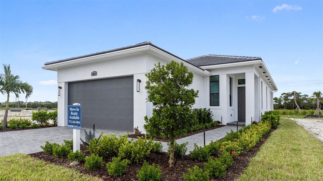 Front exterior of a new home in PGA Village Verano, Port St. Lucie, FL, highlighting curb appeal (Image 21). Front exterior of a new home in PGA Village Verano, Port St. Lucie, FL, highlighting curb appeal (Image 21).