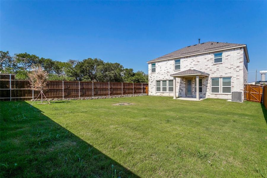 Exterior details and patio area of a home in The Preserve, Justin (Image 20).