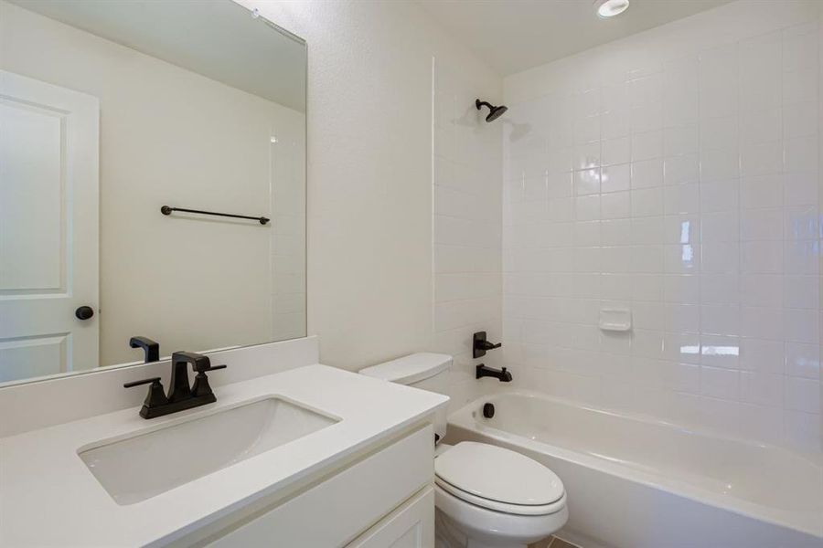Full bathroom featuring shower / tub combination and vanity